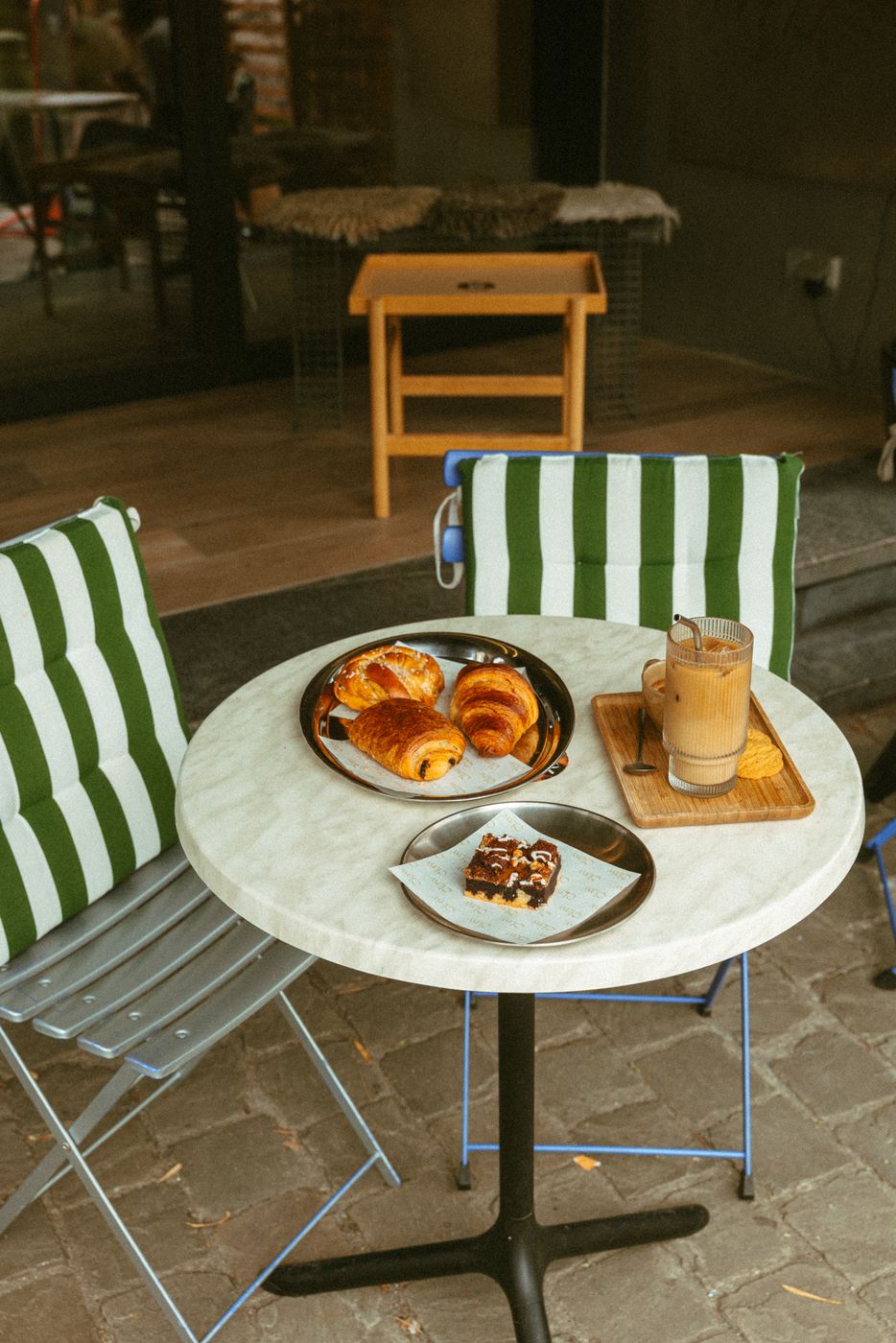Coffee, croissants and a brownie on a terrace table