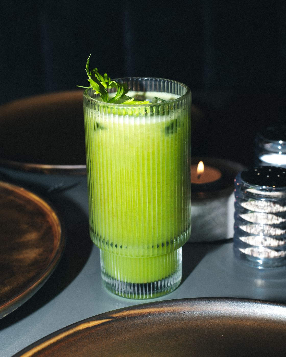 A glass of fresh green juice with celery