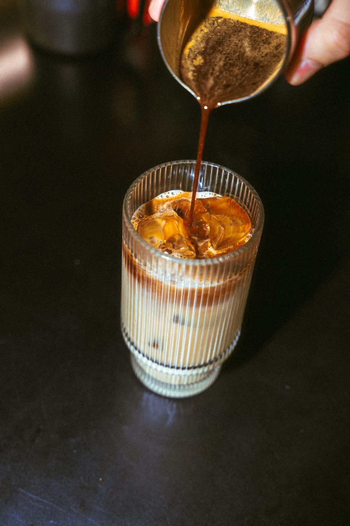 Espresso poured over an iced latte macchiato