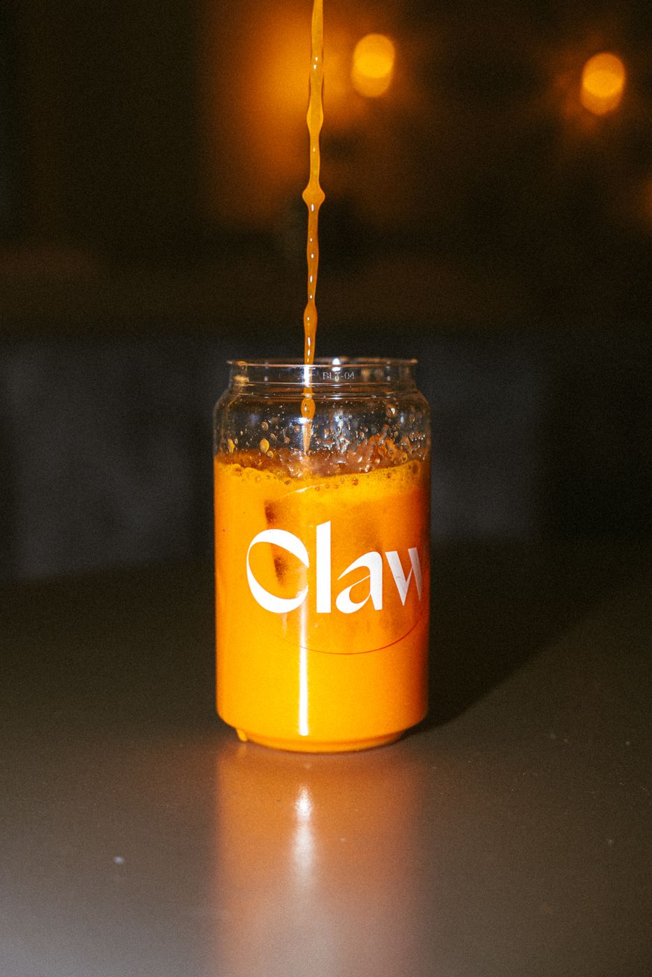 Fresh orange juice poured into a Claw jar