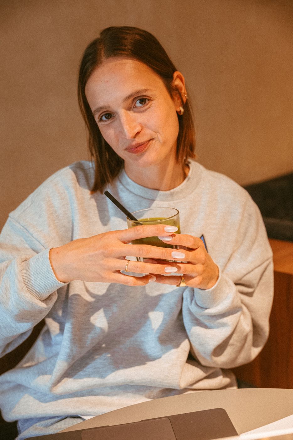 A guest holding an iced matcha latte