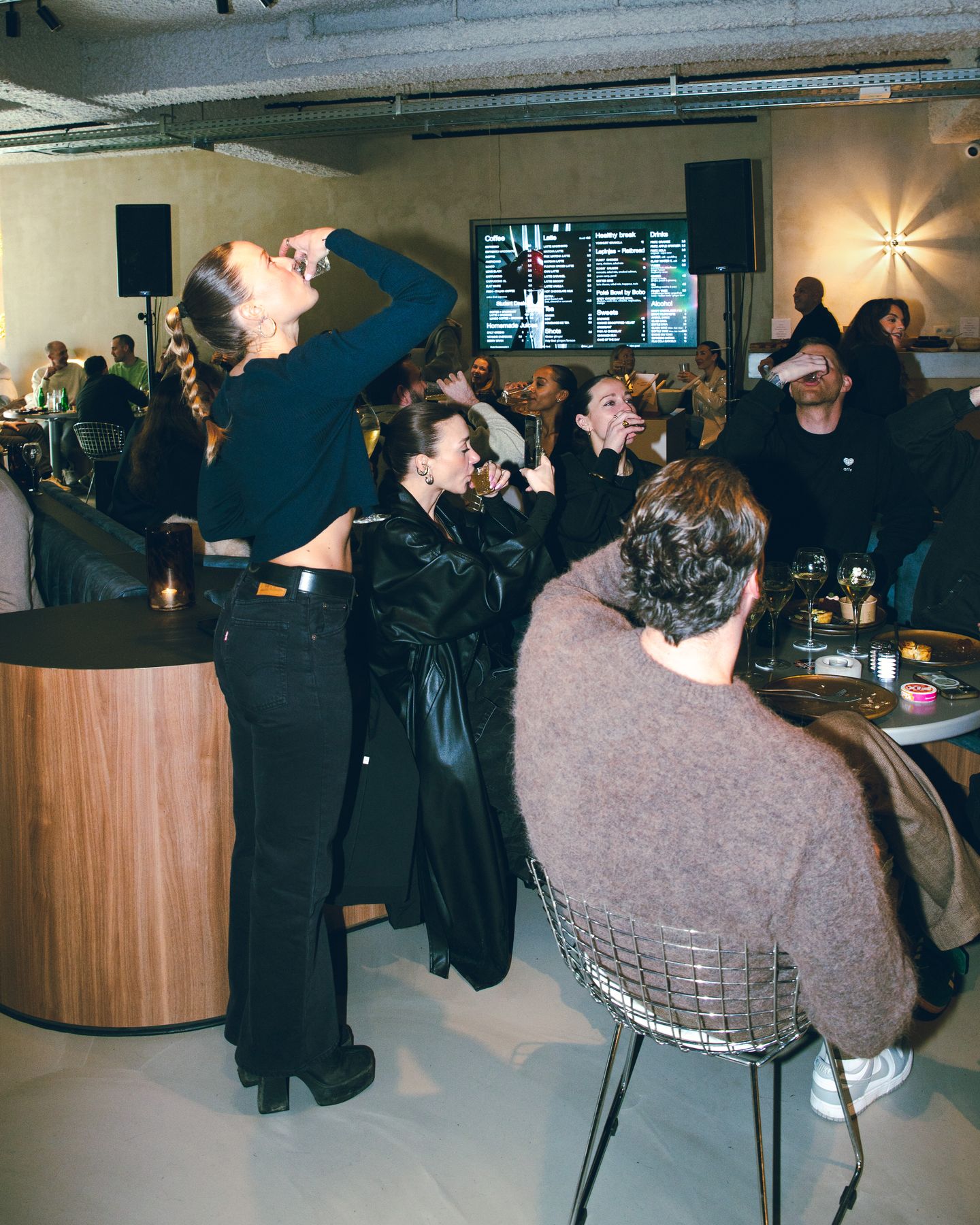 Friends raising their glasses at a Claw night