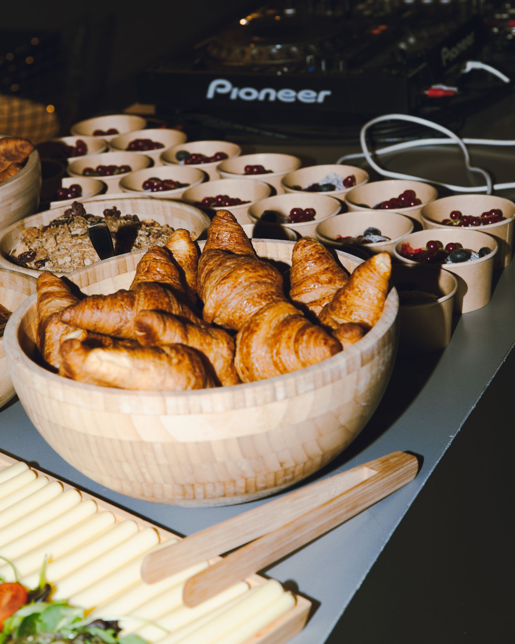 A breakfast buffet with croissants and fruit bowls