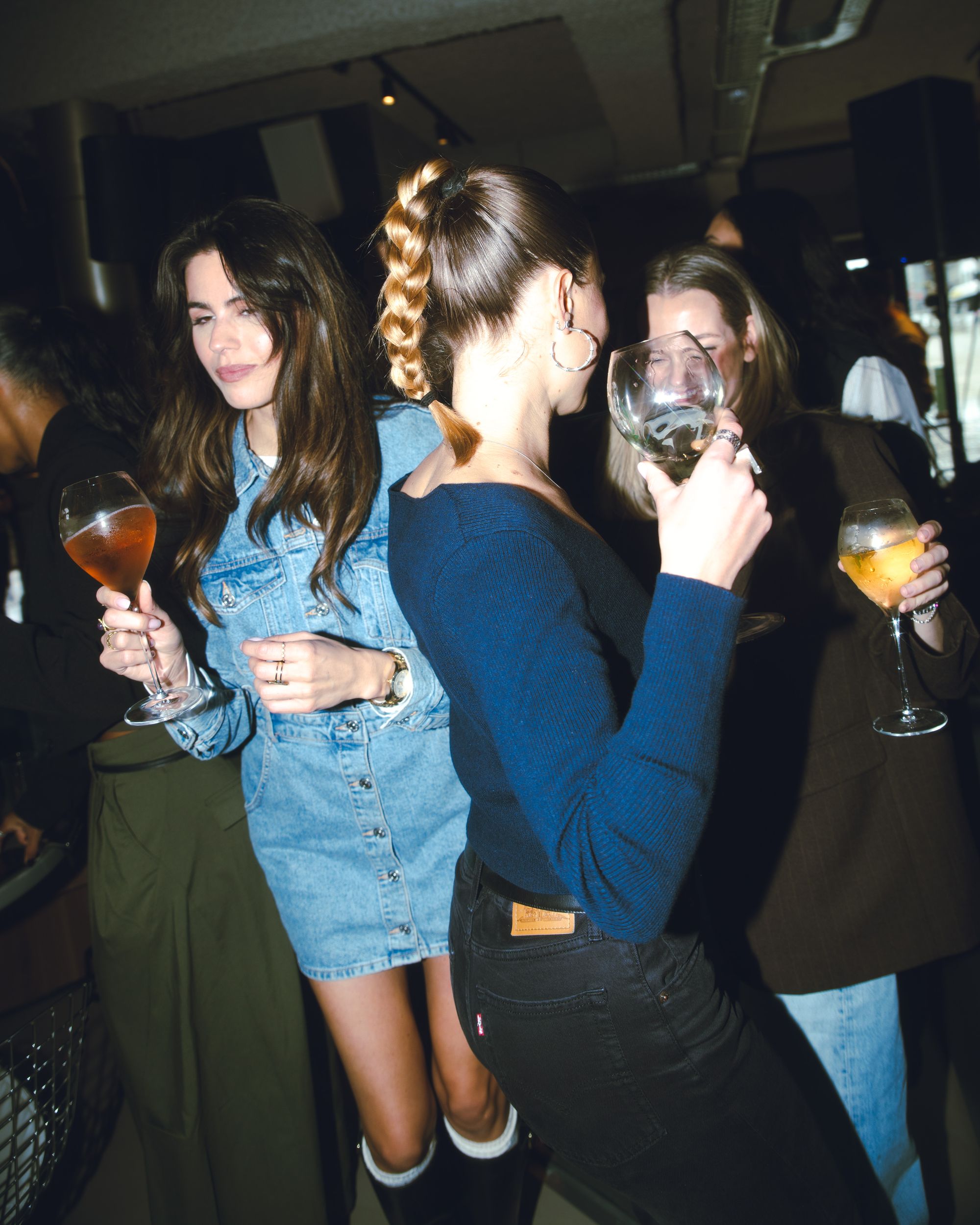 Friends with drinks at a Claw party